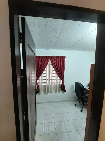 Room features: white painted walls, textured ceiling, tiled flooring, red curtains, window with sheer and blackout treatments, desk with chair, wooden furniture, door with wooden finish; style: modern.