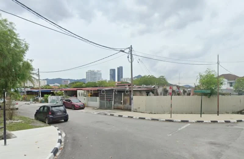 Exterior features: city skyline in background, residential street, power lines visible, mixed-use buildings, trees along the street, paved road, curved road layout, fenced properties.
