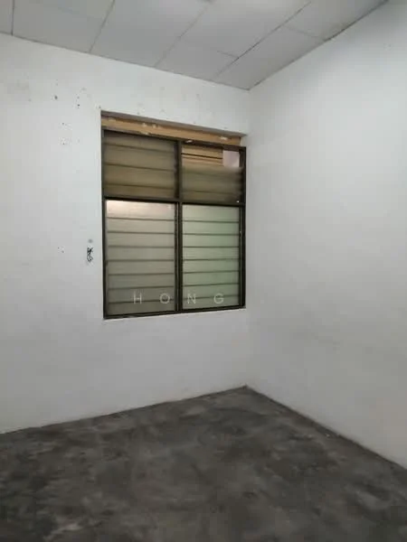 Room features: white painted walls, concrete flooring, single window with horizontal slats, no visible furnishings.