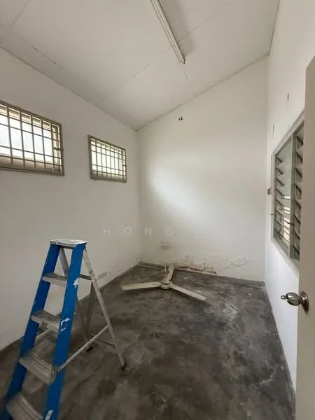 Room features: white painted walls, concrete flooring, sliding window with security bars, ceiling fan, ladder, exposed ceiling, natural light from windows.