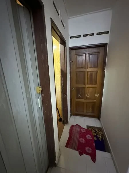 Room features: white painted walls, tile flooring, wooden door, panel door, door mat, light fixture, narrow hallway, door frame.