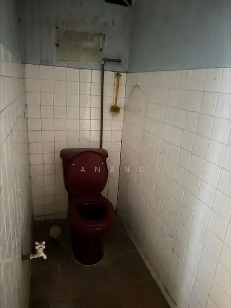 Bathroom features: one-piece toilet, white tiled walls, grey flooring, wall-mounted shower head, exposed plumbing, small window, yellow shower curtain, sink with faucet.