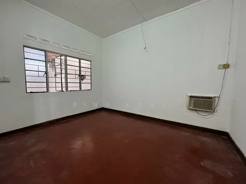 Room features: white painted walls, red cement flooring, window with metal grille, wall-mounted air conditioning unit, ceiling with no visible features, power outlet, light fixture, corner wall; style: minimalist.