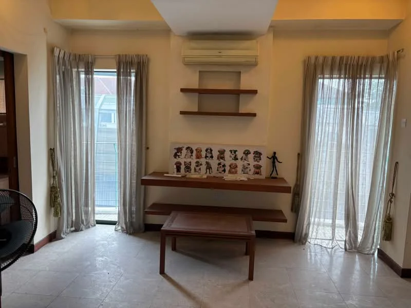 Living features: cream painted walls, tile flooring, 2 large windows with sheer curtains, wall-mounted air conditioning unit, wooden shelf unit, wooden coffee table, decorative figurine, framed artwork on shelf; style: modern.