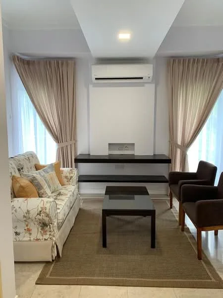 Living features: 3-seater fabric sofa with floral pattern, 2 brown upholstered armchairs, glass coffee table, area rug, wall-mounted air conditioning unit, floor-to-ceiling windows, sheer curtains, light-colored painted walls, recessed ceiling lights; style: modern.