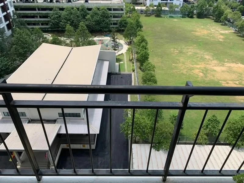 Room features: balcony with metal railing, view of green field, view of landscaped area, view of parking area, flat roof, concrete flooring; view: garden.