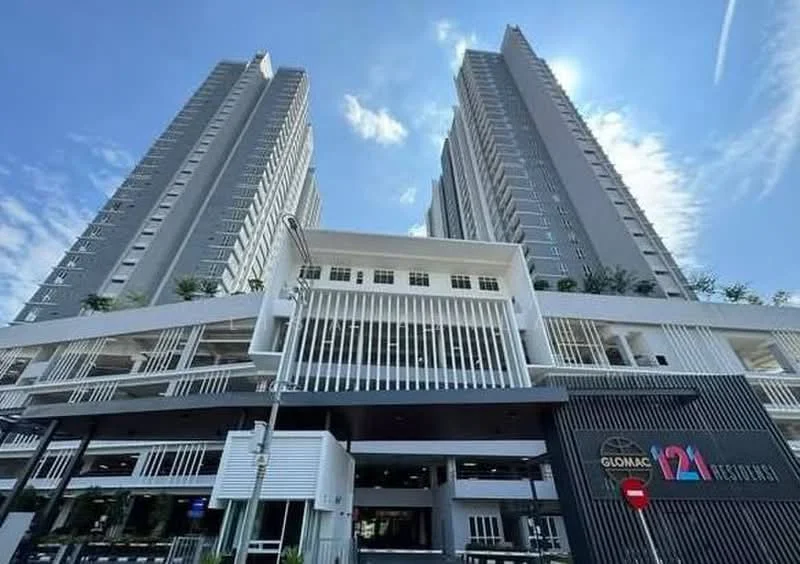Exterior type: high-rise condominium; features: grey painted facade, glass curtain wall, recessed balconies, vertical fins, manicured landscaping, two tall towers, entrance with awning, outdoor seating area; style: modern.