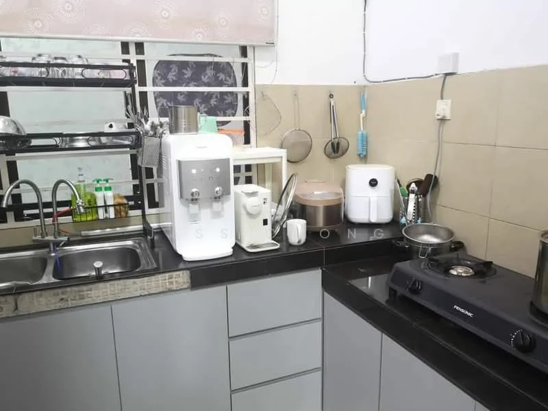 Kitchen features: double-bowl stainless-steel sink, chrome pull-down faucet, black granite countertop, grey cabinetry with flat-panel doors, water dispenser, white electric kettle, white rice cooker, freestanding gas stove with 2 burners, wall-mounted shelf for storage, ceramic tile backsplash, kitchen utensils hanging on wall, cleaning supplies on countertop; style: modern.