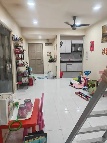 Living features: white painted walls, white tile flooring, recessed downlights, 5-blade ceiling fan, sliding glass door, open layout to kitchen, decorative wall art, shelves with decorative items, colorful children's toys, pink children's table, various household items scattered; style: modern. Kitchen features: grey cabinetry, white countertop, stainless-steel sink, built-in oven, freestanding range oven, microwave, kitchen appliances visible; style: modern.