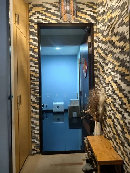 Room features: textured wall with mixed materials, blue painted walls, wooden console table, decorative vase with dried plants, hanging lantern light fixture, carpeted flooring, built-in cabinetry, doorway leading to another room; style: modern.
