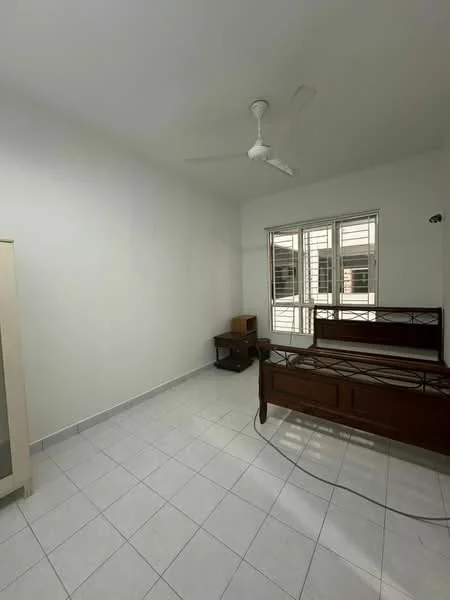Bedroom features: white painted walls, tiled flooring, ceiling fan, window with multiple panes, wooden bed frame, small wooden side table, natural light from window.