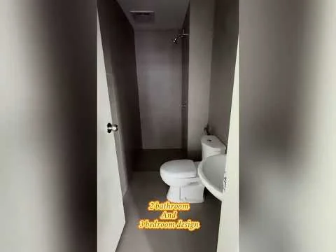 Bathroom features: one-piece toilet, sink with pedestal, grey tiled walls, grey tiled flooring, mirror above sink, ceiling light, exhaust fan, door with handle; style: modern.
