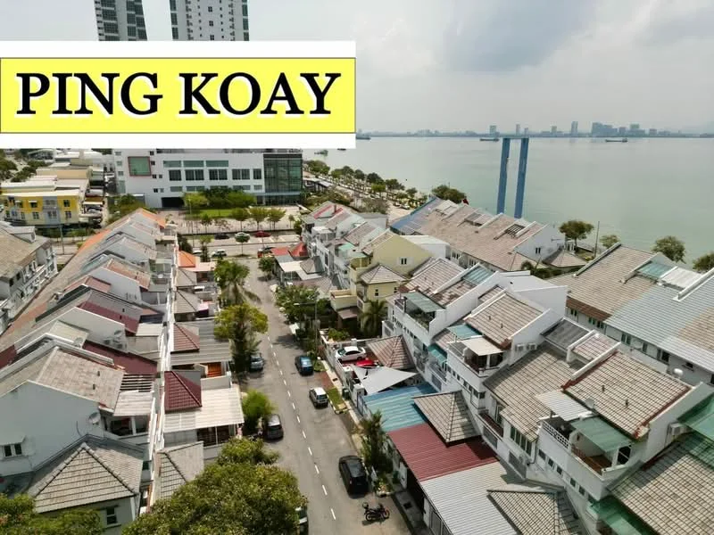 Exterior type: linked terrace house; features: two-storey linked terrace houses, pitched tile roofs, manicured lawns, paved walkways, waterfront view, surrounded by greenery, urban residential area, parking spaces visible, nearby high-rise buildings, city skyline in background; style: modern.