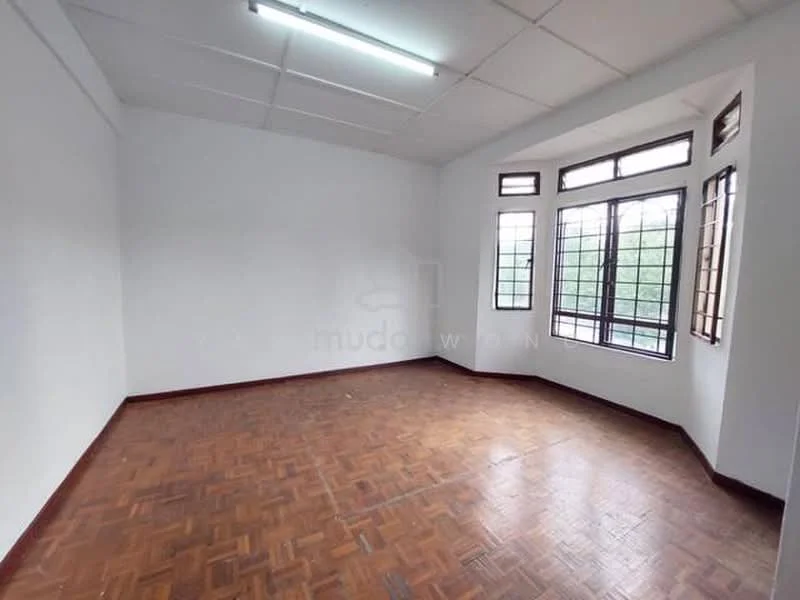 Room features: white painted walls, parquet wood flooring, large windows with grid pattern, natural light from windows, ceiling lights, corner room, no visible furniture.
