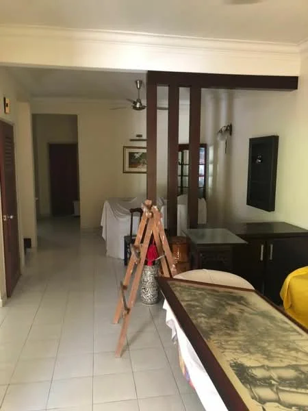 Room features: white tiled flooring, cream painted walls, wooden beams, ceiling fan, framed artwork on wall, furniture covered with white cloth, wooden cabinet, side table, decorative plant in pot; style: traditional.
