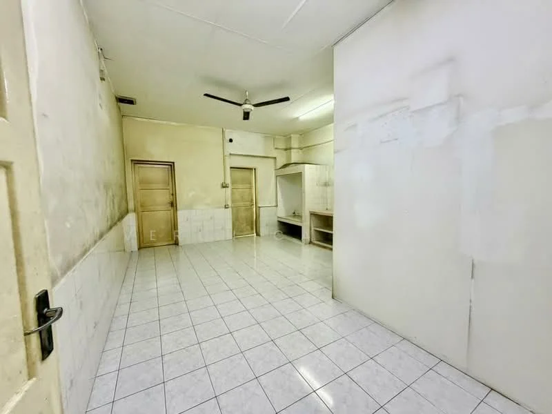 Room features: white painted walls, tile flooring, ceiling fan, single door, two doors leading to other rooms, wall-mounted shelf, fluorescent lighting.