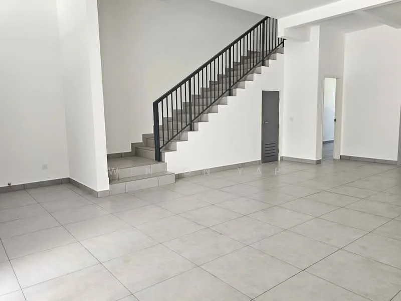 Room features: grey tiled flooring, white painted walls, staircase with black railing, high ceiling, large open space, doorway leading to another room, windows allowing natural light, corner wall with no visible features; style: modern.