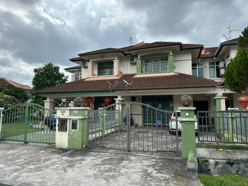 Exterior type: semi-detached house; features: two-storey structure, red tiled roof, cream and green painted facade, metal gate, front garden with grass, driveway with parking space, visible windows with grilles, decorative lanterns, surrounding trees, cloudy sky; style: modern.