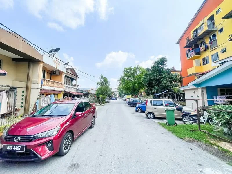 Exterior type: low-rise apartment block; features: street view, parked cars, residential buildings, trees lining the street, balconies on buildings, sidewalks, utility poles, street lighting; style: modern.