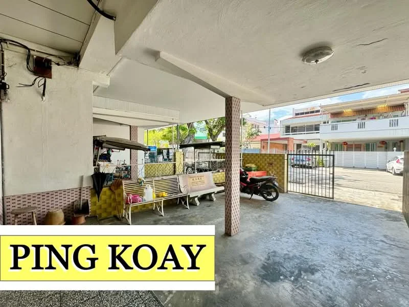 Exterior features: concrete flooring, covered parking area, metal gate, outdoor seating area with benches, motorcycle parked, surrounding greenery, exposed ceiling, brick column, yellow wall accents; style: modern.
