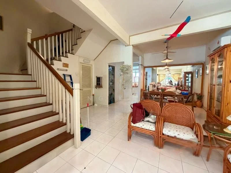 Living features: white painted walls, ceramic tile flooring, ceiling with pendant lights, wooden staircase, two rattan chairs, dining table in background, decorative plants, open layout, large windows, wall-mounted decor; style: traditional. Room features: white painted walls, ceramic tile flooring, wooden staircase, decorative plants.