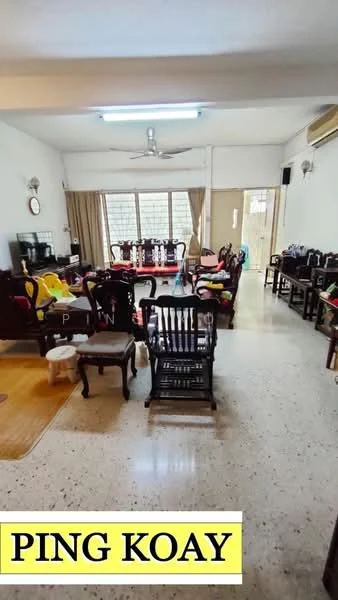 Living features: polished concrete flooring, white painted walls, ceiling fan, wall-mounted air conditioning unit, large windows with sheer curtains, wooden dining table with chairs, sofa set with cushions, decorative wall clock, area rug, wooden rocking chair, TV console, various decorative items on shelves; style: traditional.