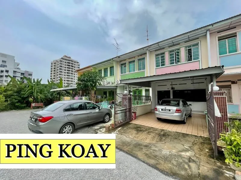 Exterior type: linked terrace house; features: two-storey building, painted facade in pastel colors, car porch with tiled flooring, two parked cars, front garden with greenery, balconies on upper floor, visible antennas on roof, surrounded by residential area; style: modern.