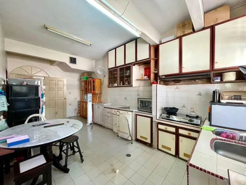 Kitchen features: white tiled walls, cream cabinetry with glass-front upper cabinets, stainless-steel sink, gas hob, built-in oven, microwave, refrigerator, round dining table, black wooden chairs, exposed beams on ceiling, tile flooring, window with sheer curtains, wall-mounted exhaust hood; style: traditional.