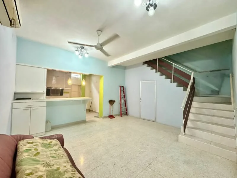 Living features: cream tiled flooring, light blue painted walls, white ceiling, 5-blade ceiling fan, recessed downlights, sofa with floral pattern, open kitchen counter, staircase leading to upper floor, door leading to another room, ladder against wall; style: modern.