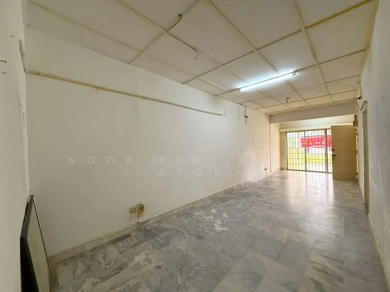 Room features: white painted walls, marble flooring, drop ceiling with fluorescent lights, large windows with metal grilles, open layout, no visible furniture, neutral color scheme, exposed electrical wiring; style: minimalist.