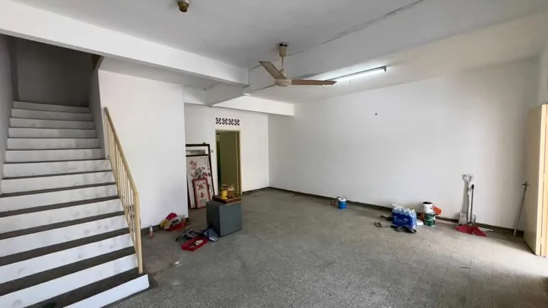 Room features: white painted walls, grey tiled flooring, 5-blade ceiling fan, staircase with wooden railing, recessed lighting, doorway leading to another room, empty space, clean and minimal decor; style: minimalist.