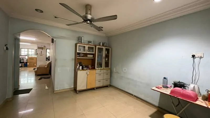 Room features: light blue painted walls, cream tiled flooring, 5-blade ceiling fan, built-in cabinetry with glass doors, open shelving, table with red tablecloth, kettle on table, water dispenser, wall-mounted electrical outlets, arched doorway leading to another room.