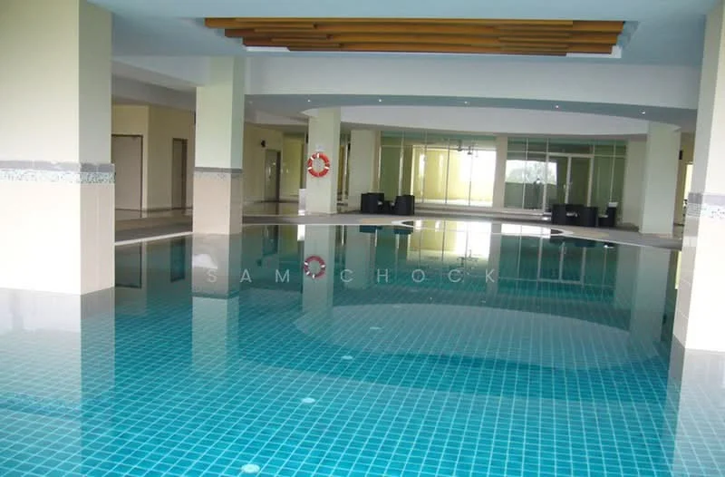 Room features: indoor swimming pool, tiled flooring with blue mosaic tiles, large windows for natural light, wooden ceiling with recessed lighting, sitting area with black furniture, lifebuoy on wall, neutral painted walls, open layout; style: modern.