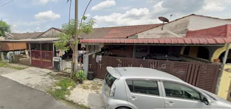 Exterior type: linked terrace house; features: single-storey, red tiled roof, wooden fence, front porch with car parking, visible satellite dish, manicured lawn, concrete pathway, surrounded by greenery; style: traditional.