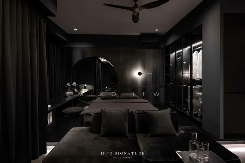 Bedroom features: dark grey walls, black accent wall with vertical panels, floor-to-ceiling curtains, dark upholstered bed, round mirror, built-in wardrobe with glass doors, recessed lighting, ceiling fan, decorative wall sconce, plush area rug, glass side tables, minimalist decor; style: modern.