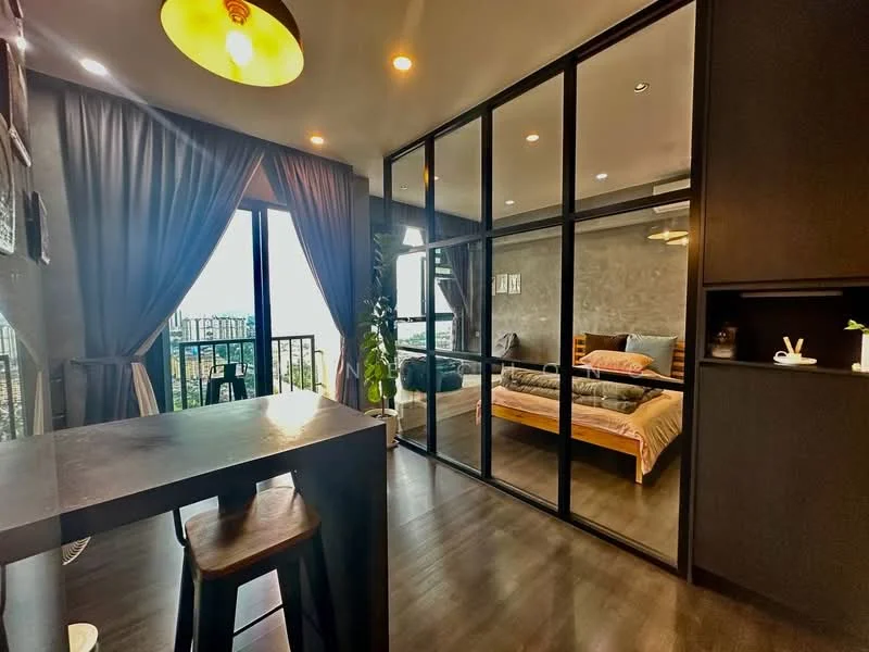 Living features: floor-to-ceiling windows, black framed glass partition, dark wood flooring, grey accent wall, recessed downlights, ceiling fan, dining table with stools, curtains, indoor plant, decorative items on shelf; style: modern; view: city. Bedroom features: queen-size bed, wooden bed frame, bedding with neutral tones, decorative wall art, nightstand, table lamp, built-in wardrobe, sliding mirror wardrobe; style: modern; view: city.