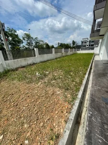 Exterior features: grassy area, dirt patch, concrete boundary wall, paved walkway, surrounding trees, clear sky, residential buildings in background; style: modern.