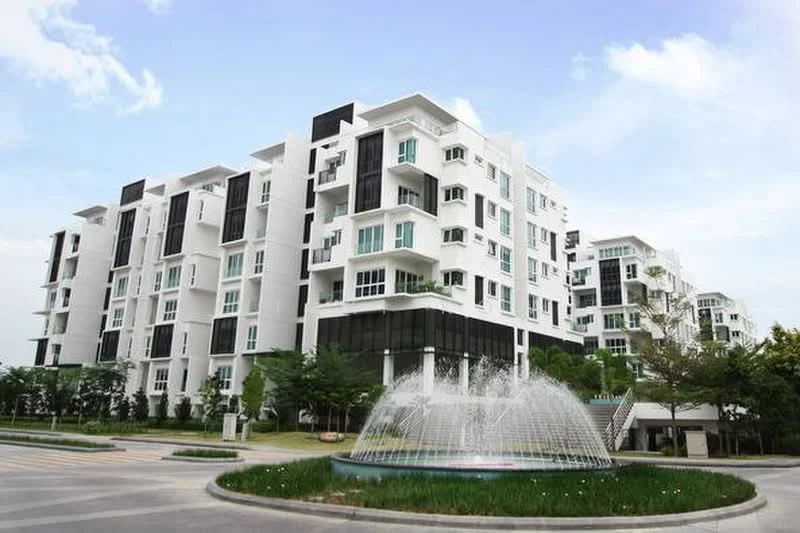 Exterior type: mid-rise condominium; features: white painted facade, glass curtain wall, recessed balconies, manicured lawn, fountain feature, landscaped garden, multiple windows, parking area, surrounded by greenery; style: modern.