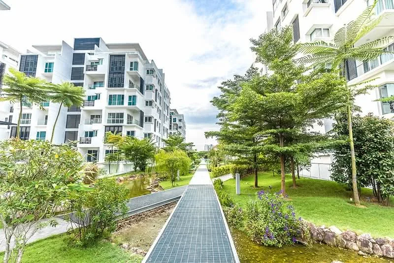 Exterior type: low-rise apartment block; features: landscaped garden, manicured lawn, pathway with solar panels, pond with greenery, mature trees, balconies on buildings, modern architectural design, surrounded by greenery; style: modern.
