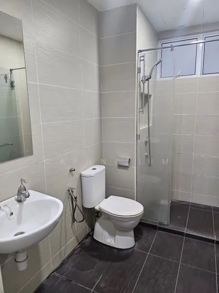 Bathroom features: white ceramic sink, chrome faucet, one-piece toilet, glass shower enclosure, rain shower head, wall-mounted shower control, grey tiled walls, dark ceramic tile flooring, mirror above sink, window for natural light; style: modern.
