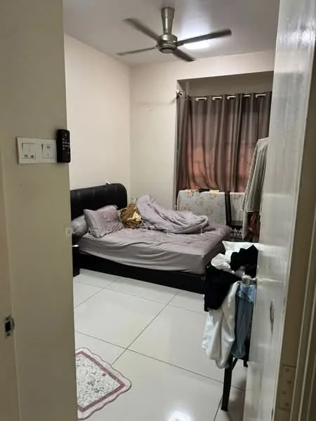 Bedroom features: queen-size bed with grey bedding, upholstered headboard, 2 bedside lamps, ceiling fan, floor-to-ceiling window with brown curtains, white walls, white tiled flooring, decorative area rug, clothes on a chair, clothes hanging on a door.