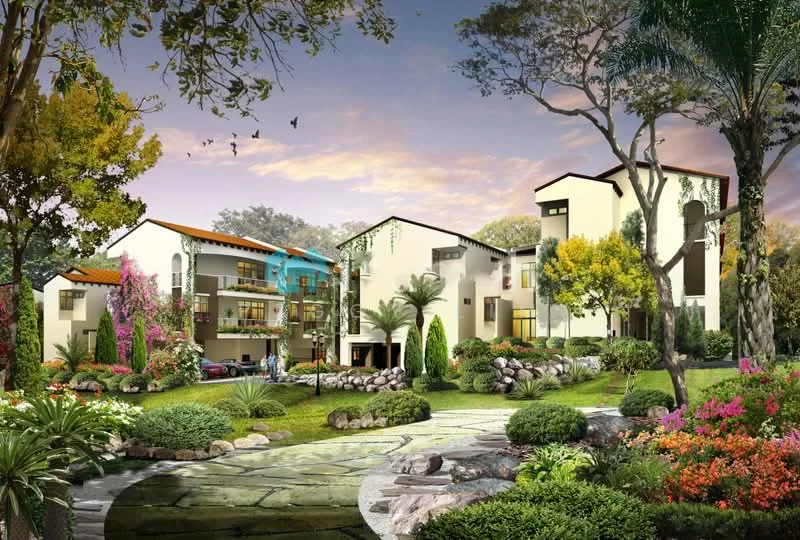 Exterior type: low-rise apartment block; features: manicured lawn, mature trees, tropical landscaping, flower beds with colorful plants, stone-paved walkway, balconies with glass railings, multiple levels, car parking area visible, modern architectural design, surrounded by greenery; style: modern.
