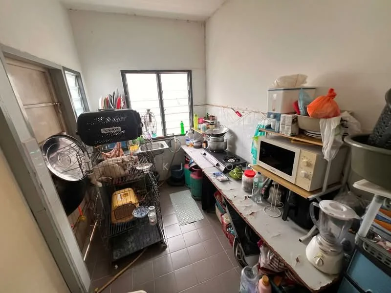 Kitchen features: grey tiled flooring, white painted walls, single-bowl stainless-steel sink, chrome pull-down faucet, microwave, blender, toaster, multiple storage containers, metal shelving unit, countertop with various appliances, window with grid pattern, kitchen utensils and dishes.