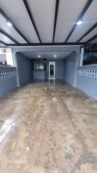 Room features: grey painted walls, exposed beams on ceiling, polished concrete flooring, double-door entrance, security grille, open layout, natural light from windows, no visible furniture; style: modern.