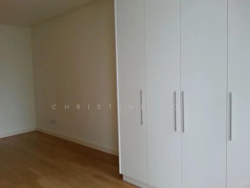 Room features: white built-in wardrobe with handles, light wooden flooring, plain white walls; style: modern.