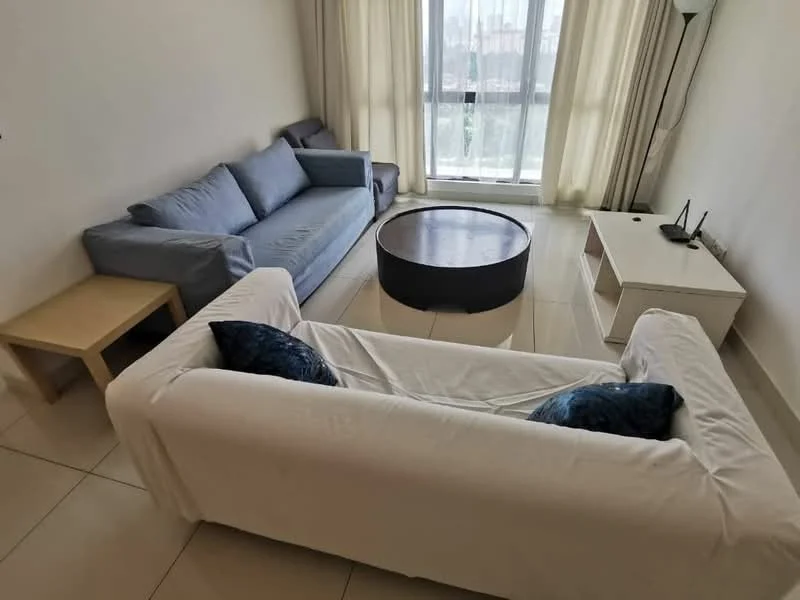 Living features: 3-seater fabric sofa in grey, 2-seater fabric sofa in blue, round coffee table in dark wood, white TV console, floor-to-ceiling windows, sheer curtains, light-colored tiled flooring, lamp in corner; style: modern; view: city.
