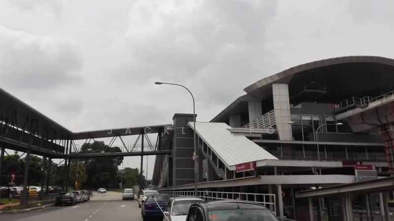 Exterior type: shopping mall; features: modern architectural design, metal roofing, glass facade, covered walkways, multiple levels, outdoor parking area, signage visible, surrounded by greenery; style: contemporary.