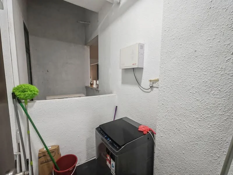 Laundry features: white painted walls, black tile flooring, front-load washing machine, wall-mounted air conditioning unit, cleaning supplies storage, small red bucket, green cleaning mop.