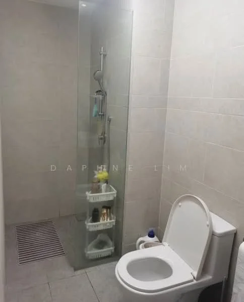 Bathroom features: glass shower enclosure, rain shower head, handheld shower, white toilet, white toilet tank, grey tiled walls, light grey tiled flooring, shower caddy with toiletries, bath mat, wall-mounted shower controls; style: modern.