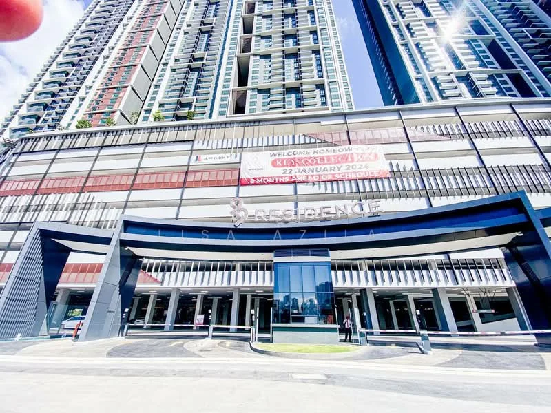 Exterior type: high-rise condominium; features: glass curtain wall, red and grey painted facade, double-volume main lobby, feature signage at entrance, surrounded by urban landscape, multiple storeys visible; style: modern.
